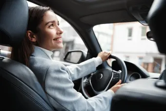woman smiles up in a car